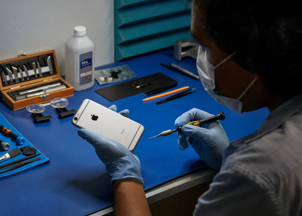 iPhone screen repair technician replacing cracked display